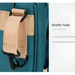 Hands-free_baby_diaper_bag_with_stroller_hooks_and_padded_straps__Green